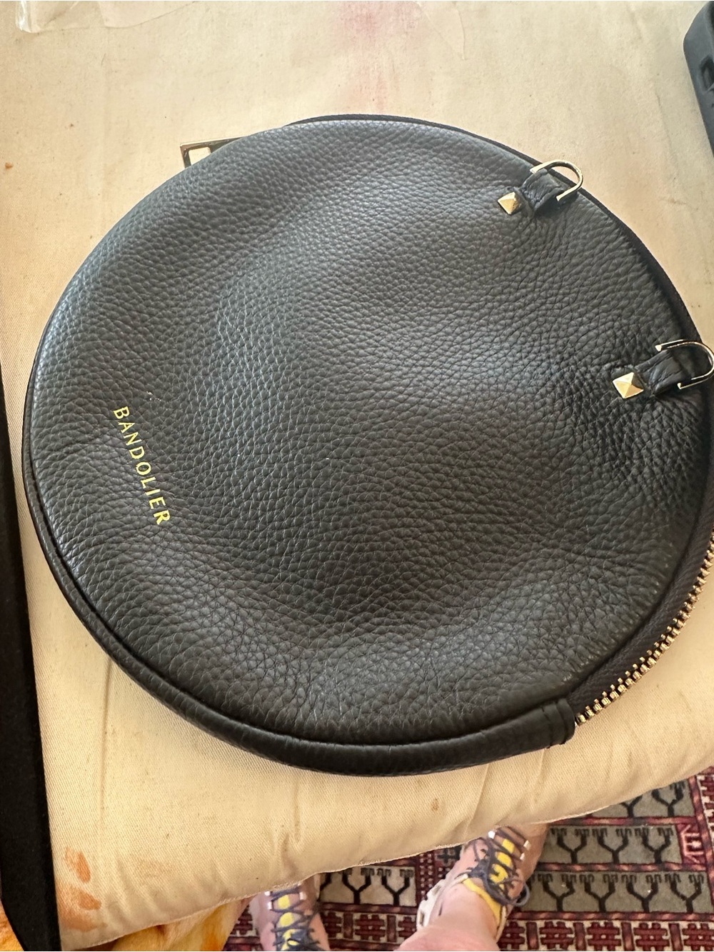 Bandolier Black Pebbled Leather Round Belt Bag with Gold Accents